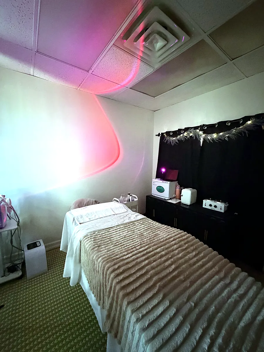 Emily's treatment suite with a treatment bed and red LED light